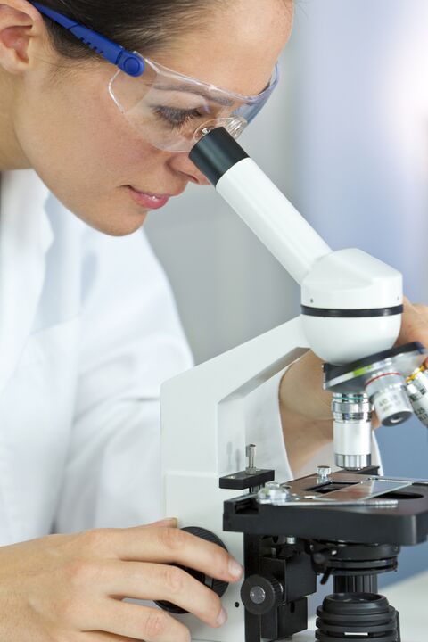 woman looking at a microscope