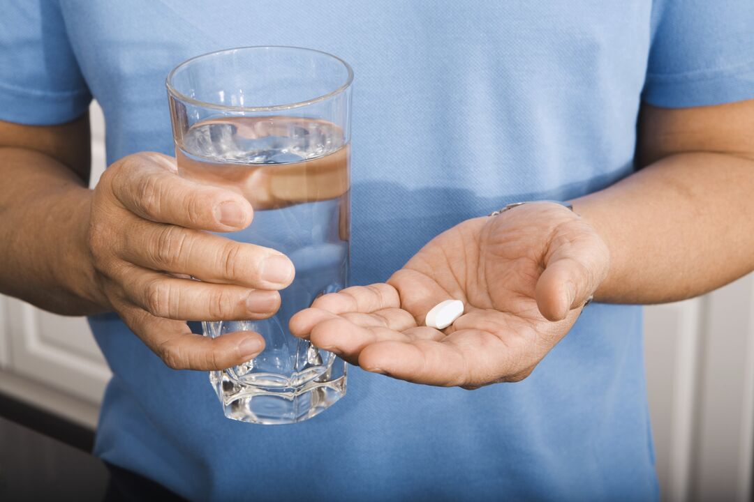 a man taking a pill against parasites